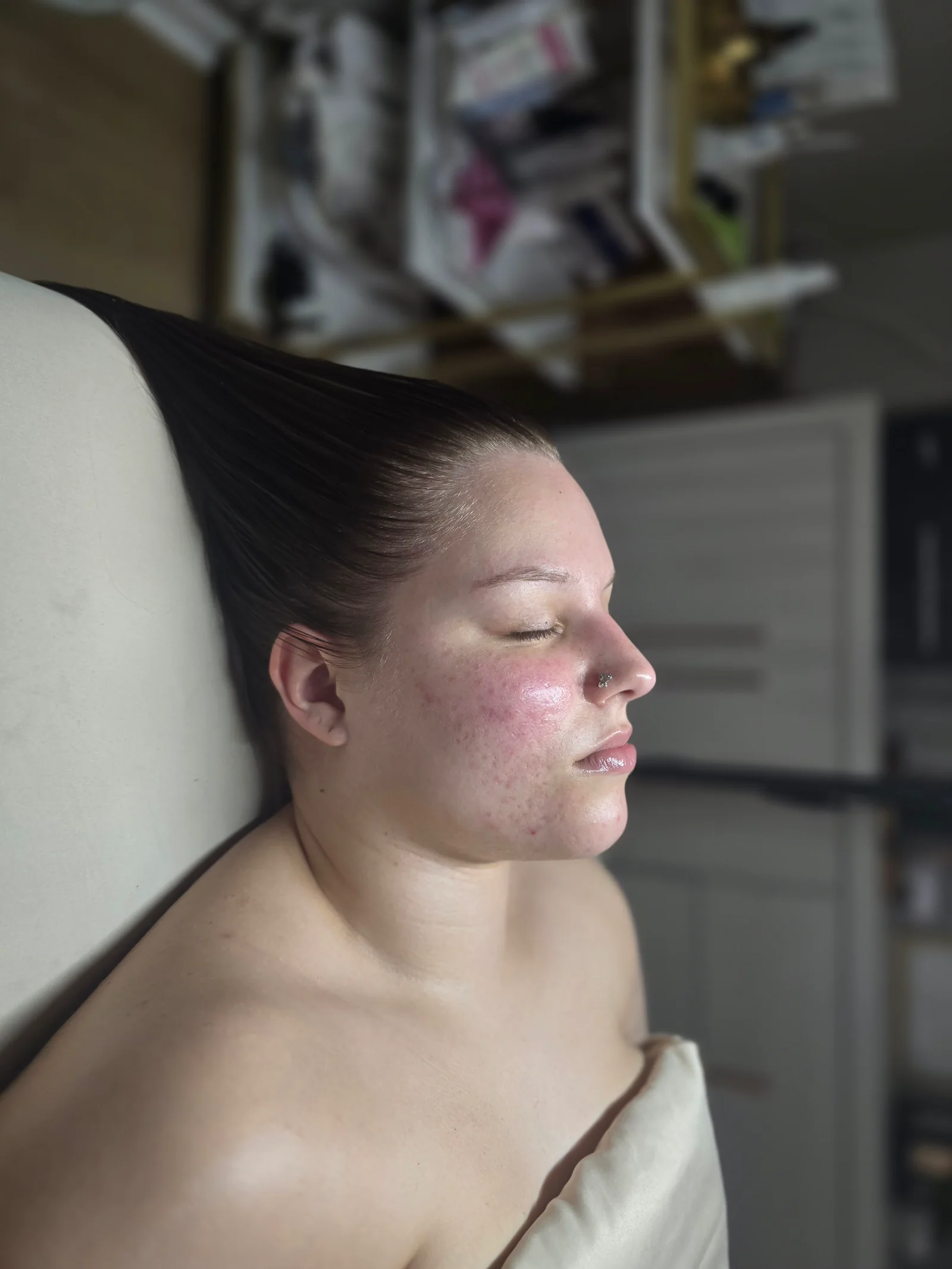 Client showing her results after a facial at Awakened Beauty in Centerville
